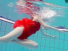 Red Dressed Teen Swimming With Her Eyes Opened