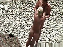 Busty blonde nudist swimming in the water