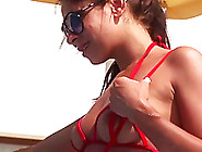 Hot brunette babe posing in tiny slingshot bikini