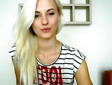 Hot blonde babe in a short top and denim shorts poses sexil