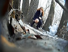 Ginger Bridesmaid Makes Water Behind A Tree In The Forest