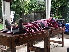Wool mohair layers of sweaters on a bondage table