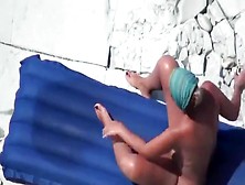 Slutty woman is giving her hubby a perfect handjob on the beach