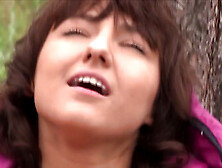 Suzy Rainbow takes on Daphne J in the rain,  in the woods