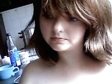 Brunette girl sucks a vibrator, masturbates in the kitchen and squirts.