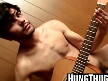 Handsome guy plays guitar while jerking off alone
