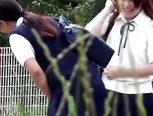 Japanese schoolgirl teens are teasing each other while peeing