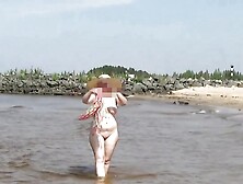 Naked hot MILF on a nude beach.