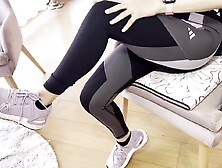 A Woman Warms up After the Gym by Touching Her Sweaty Feet