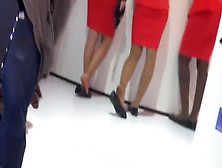 Attractive models exposing their beautiful feet at the car show