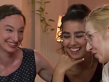 Four naked and horny girls are having sex on the couch