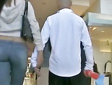 Tall,  sexy girl in jeans showing off her butt for the candid camera