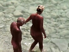 Handjob given by mature wife on public beach