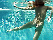 Underwater solo teen swims in the nude