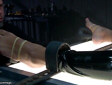 Chained and lied on her back in latex costume black serf Daisy Ducati gets feet tormented then spanked and whipped and anal fing