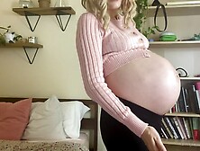 Pregnant Woman slapping her Belly