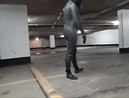 Wetsuited & Masked In Parking Garage