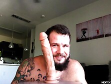 Tattooed Solo Guy Spreads His Legs To Ride A Massive Dildo At Home