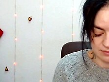 Brunette babe in grey sweater posing