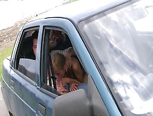 Blonde is getting penetrated in the back seat of a car outside