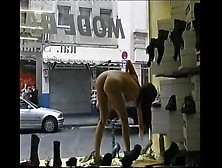 Nude chick washing windows in public