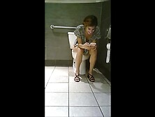 Toilet voyeur - Cute brunette going commando