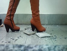 Naughty woman in sexy brown boots getting wild while crushing keyboard