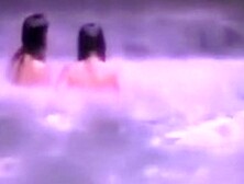 Naked maids swimming under the waterfall