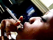 Black girl smokes cigarette solo