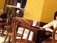 Upskirt (fake) of a lonely girl in a coffee shop